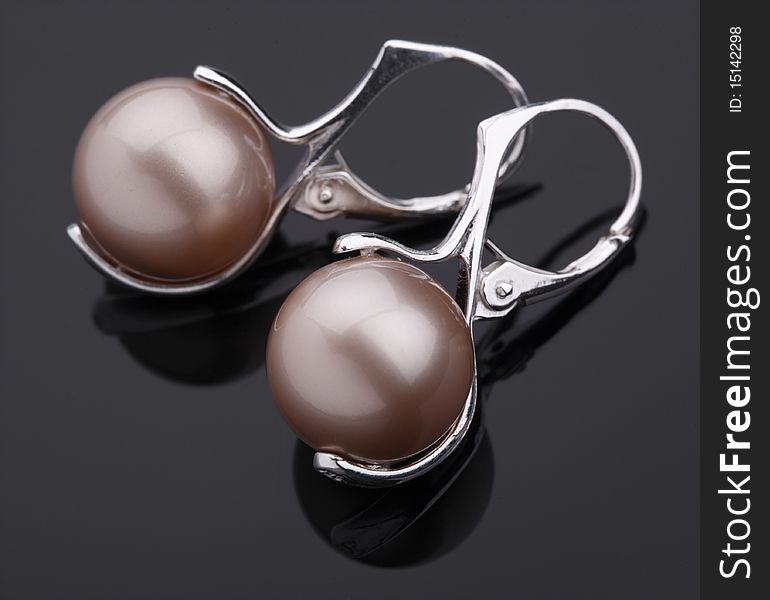 Silver earring with pearl  on the grey background