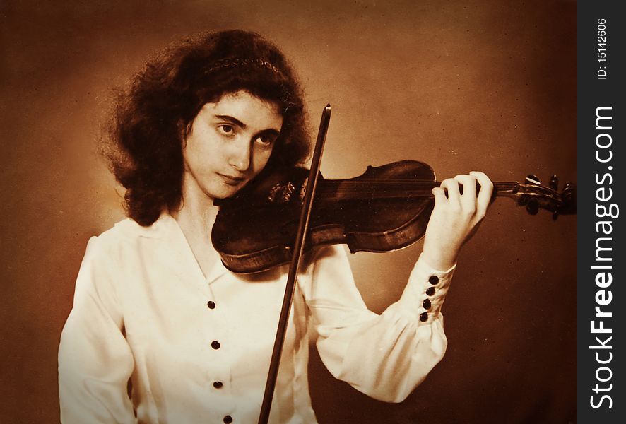 Vintage photo of a girl playing violin. Vintage photo of a girl playing violin