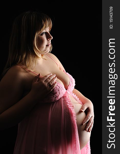 Pregnant woman on a black background