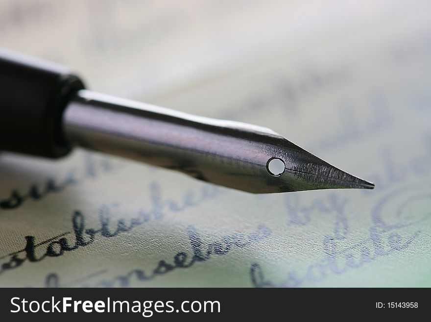 Metal pen for drawing or the letter Chinese ink or drafting ink with a background in the form of the ancient text.