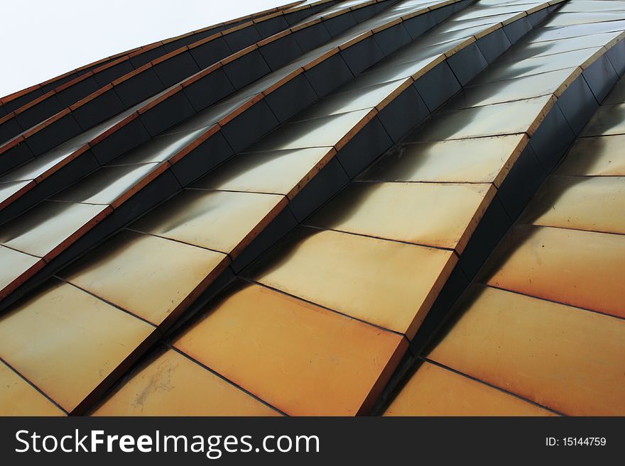 Golden metal roof of a mordern building. Golden metal roof of a mordern building