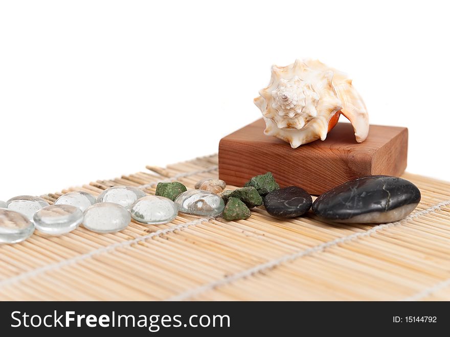 Shells, stones and pebbles on a bamboo mat. Shells, stones and pebbles on a bamboo mat