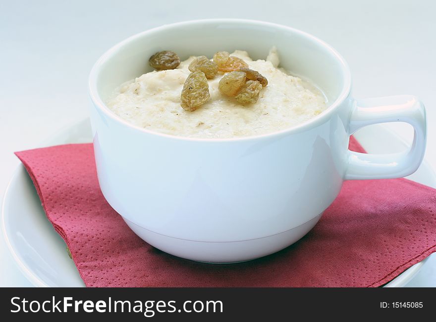 A cup of oatmeal porridge for the breakfast. A cup of oatmeal porridge for the breakfast