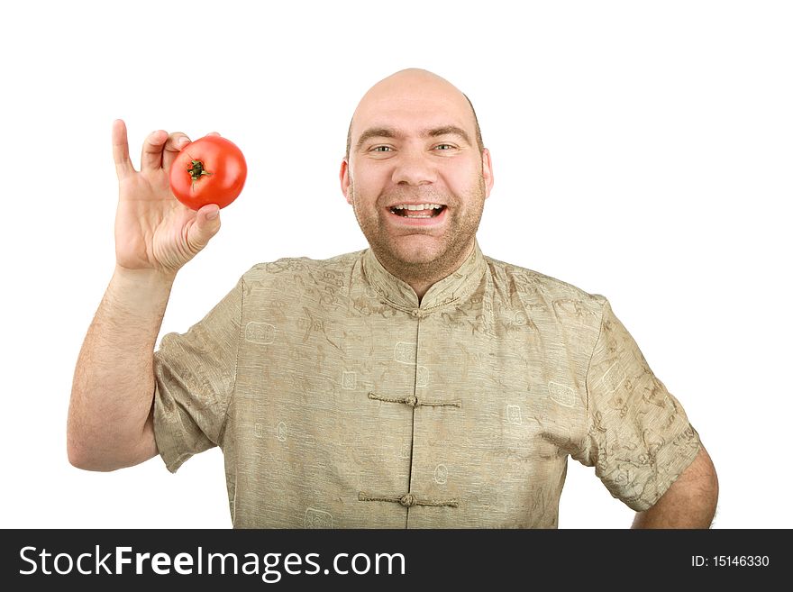 The smiling man holds a tomato on a white background