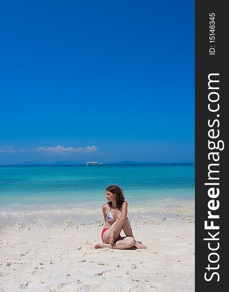 Woman doing yogastic exericise on the beach