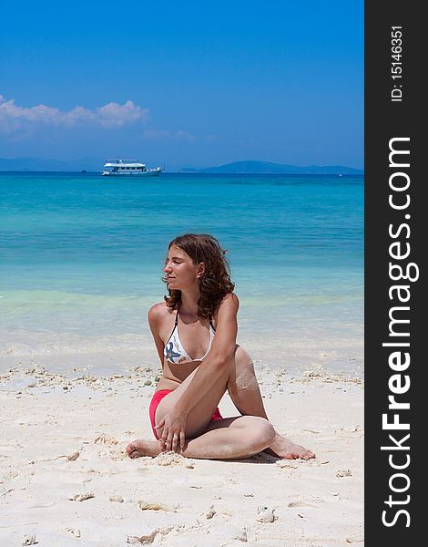 Woman doing yogastic exericise on the beach