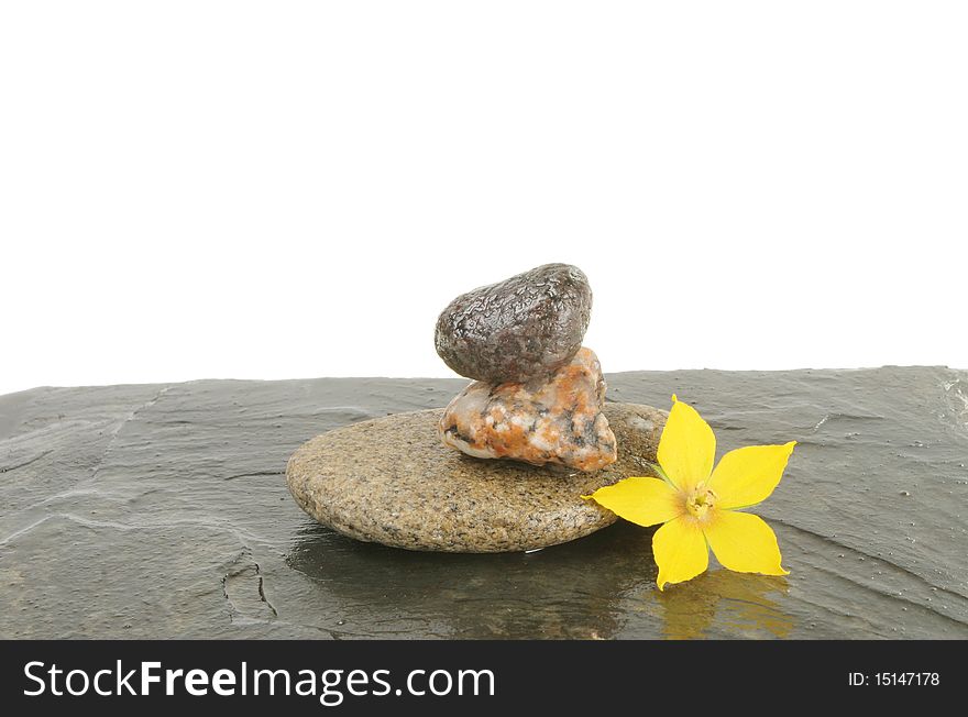 Small pebble cairn and a yellow flower. Small pebble cairn and a yellow flower