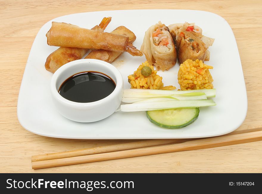 Selection of Chinese snacks on a plate on a wooden table