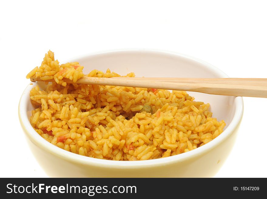Closeup of rice and chopsticks in a bowl against a white background