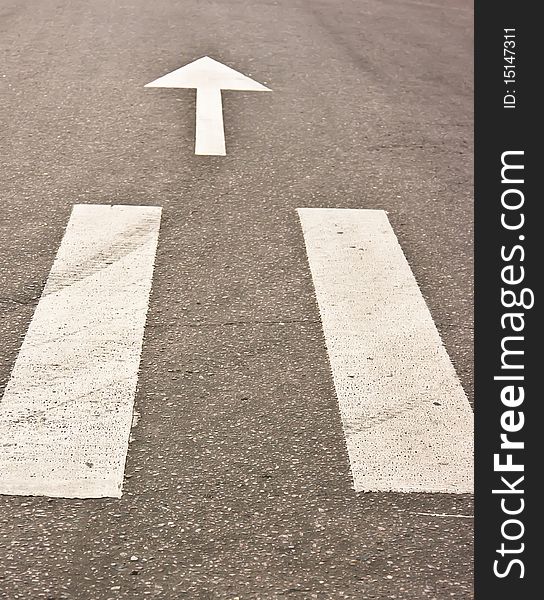 Pedestrian crossing and arrow on road at day. Pedestrian crossing and arrow on road at day