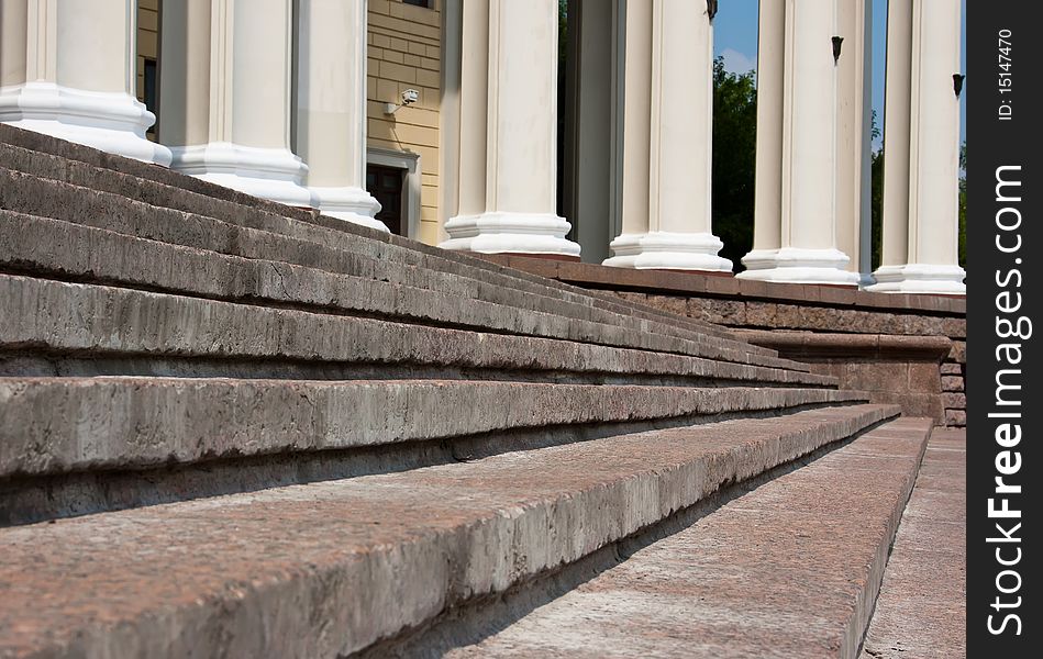 Old stone broken staircase and white pillars