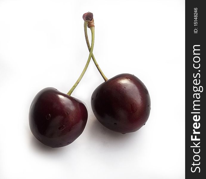 Two cherries on a white background