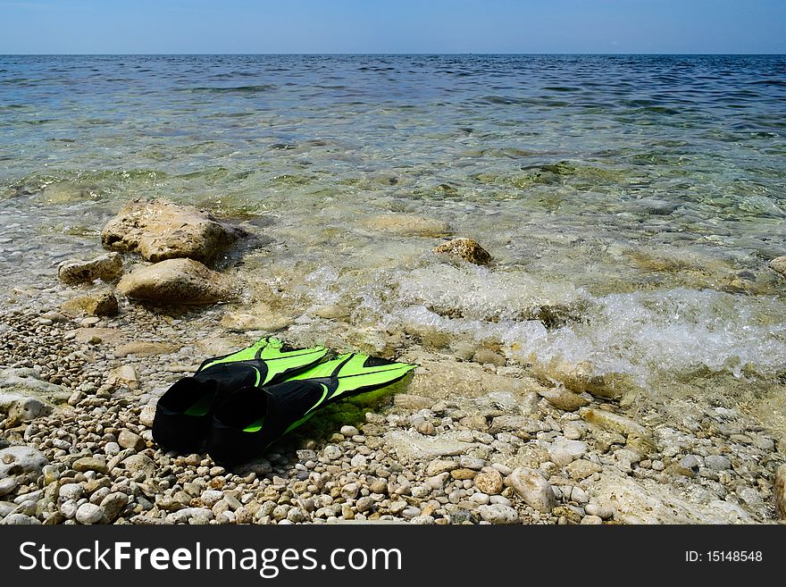 Scuba snorkeling green flippers set at seaside. Scuba snorkeling green flippers set at seaside