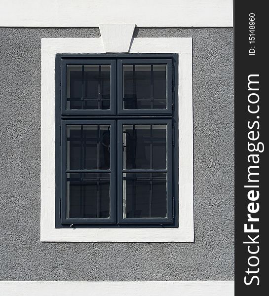 Window on a house with gray wall