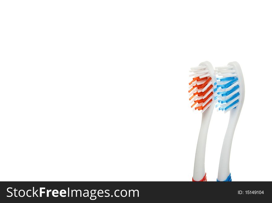 Red and blue toothbrushes lying on a white background