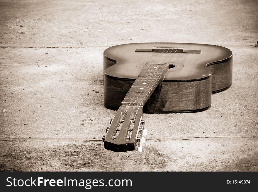 Sepia classical guitar at stone