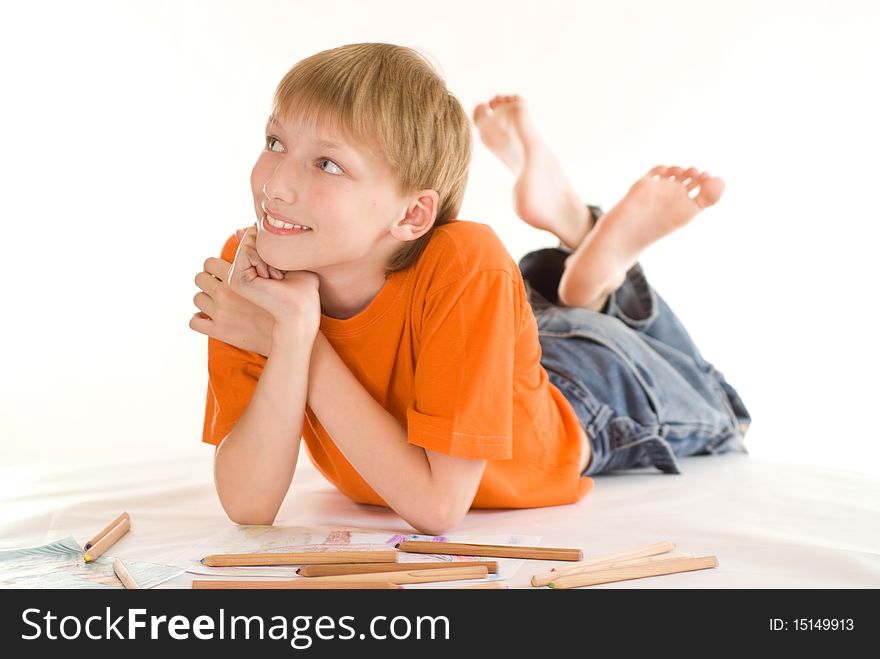 Boy lying on the floor and draw. Boy lying on the floor and draw