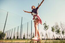 Beaming Teenage Girl Actively Riding On A Skateboard And Spreading Her Hands Royalty Free Stock Photos Beaming Teenage Girl Actively Riding On A Skateboard And Spreading Her Hands Royalty Free Stock Photos