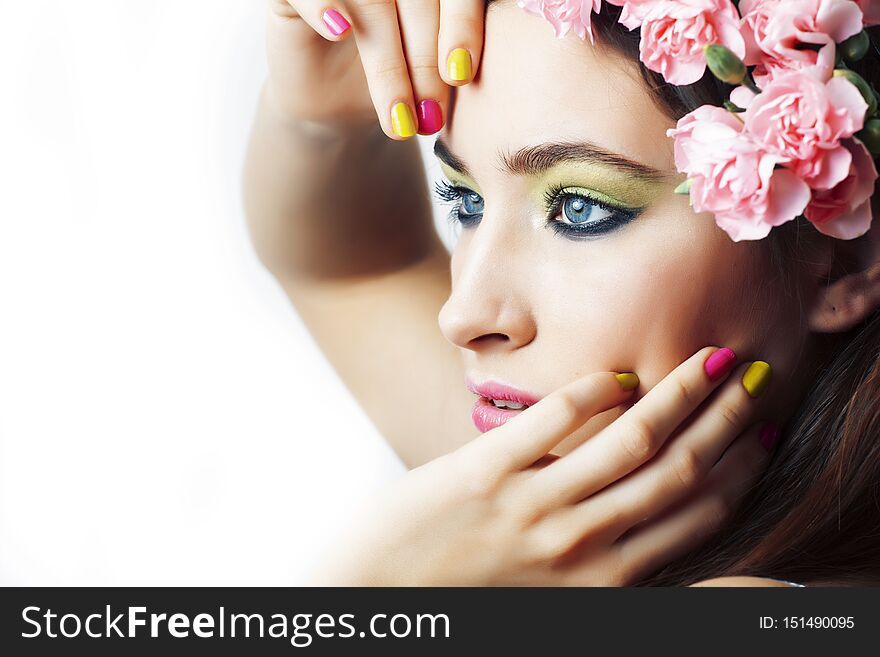 Young pretty brunette woman with pink flowers and manicure posing cheerful isolated on white background closeup