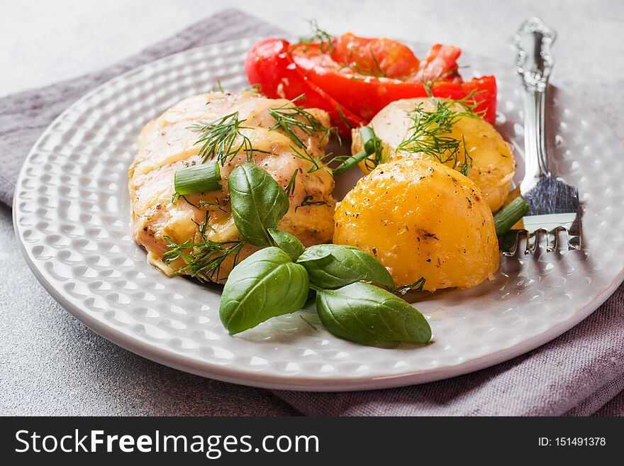 Baked potatoes with chicken and vegetables on a plate