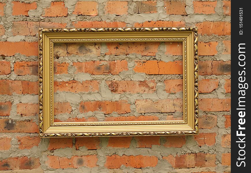 Picture frame from baguette on the background of an old brick wall.