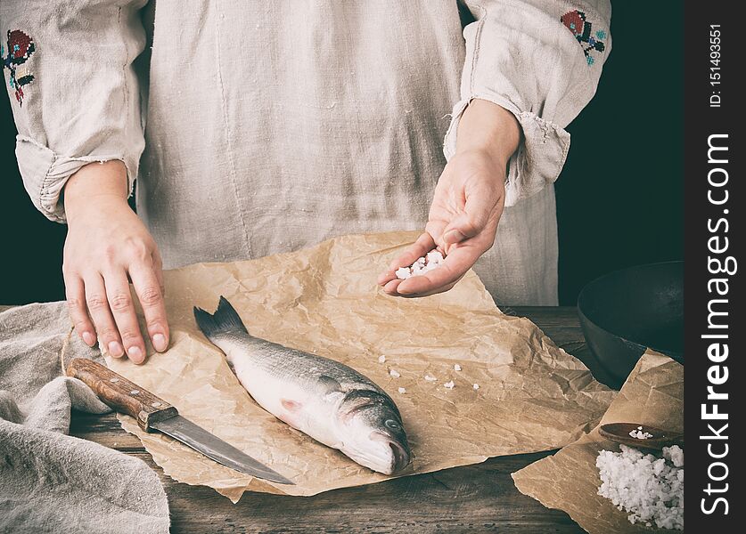 Fresh Whole Sea Bass Fish Lying On Brown Paper