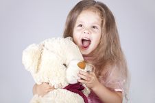 Little Shouting Girl Embraces Bear Cub. Royalty Free Stock Images Little Shouting Girl Embraces Bear Cub. Royalty Free Stock Images