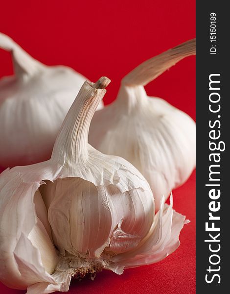 Garlic on red background, half clove