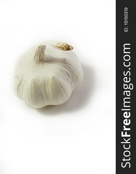 High-key portrait of whole garlic clove from above against white background. High-key portrait of whole garlic clove from above against white background