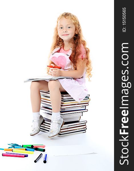 Portrait of a little girl sitting on a stack of books. Over white background. Portrait of a little girl sitting on a stack of books. Over white background.