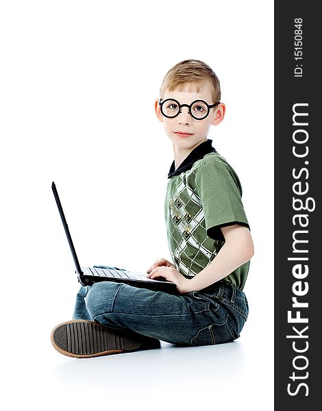 Shot of a boy sitting with his laptop. Isolated over white background. Shot of a boy sitting with his laptop. Isolated over white background.