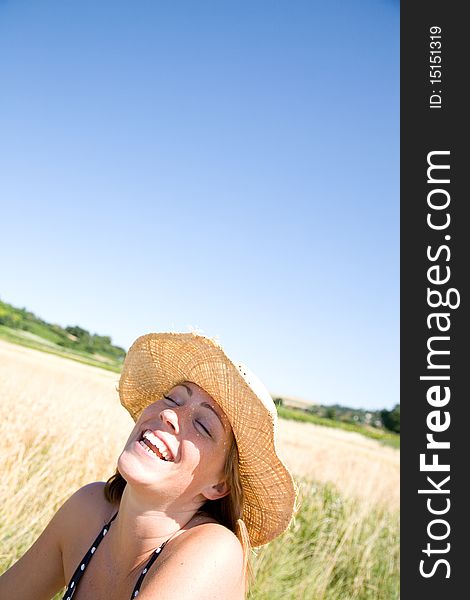 Young woman laughing on a summer day