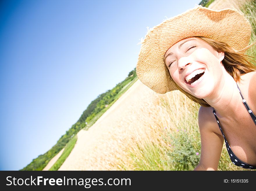 Young woman laughing on a summer day