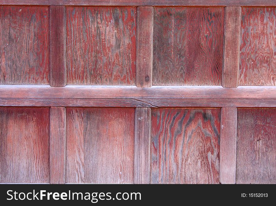 Weathered red wooden garage door background. Weathered red wooden garage door background