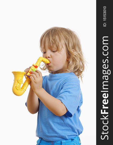 Boy with long blond hair playing with toy saxophone. Boy with long blond hair playing with toy saxophone