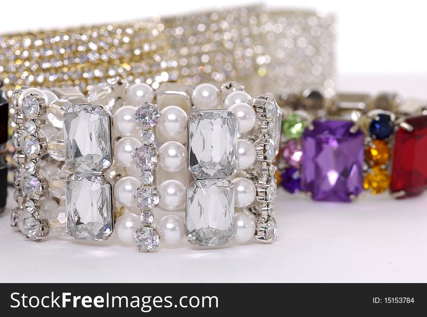 Stack of fashion bracelets on white