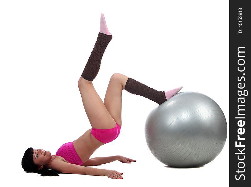 Attractive brunete girl doing gymnastic excersises with a ball. Attractive brunete girl doing gymnastic excersises with a ball