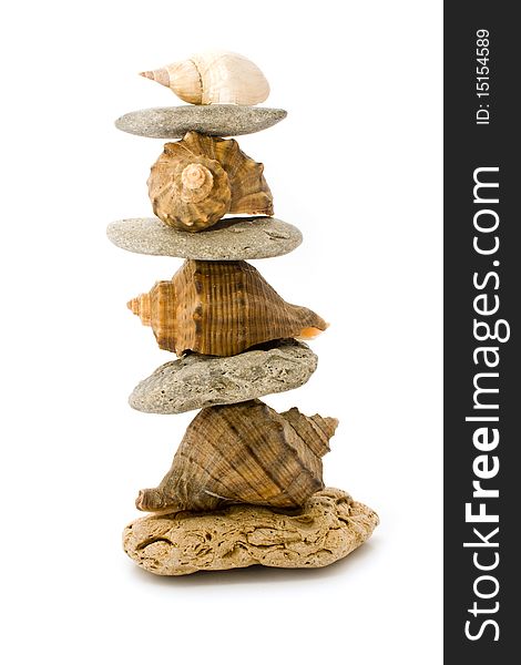 Pyramid of stone and cockleshells on a white background