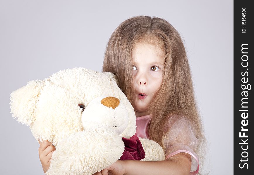 Little Shouting Girl Embraces Bear Cub.