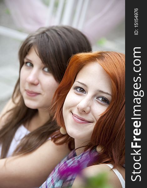 Portrait of two beautiful girls. Outdoor photo.