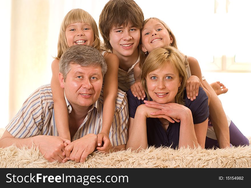Portrait of a happy family of five on a light background