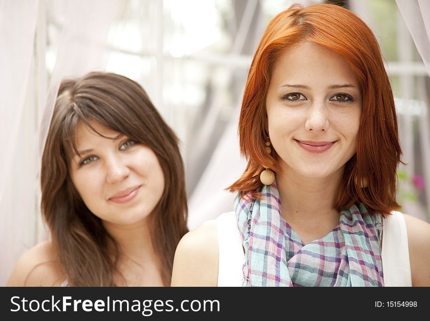 Portrait of two beautiful girls. Outdoor photo.