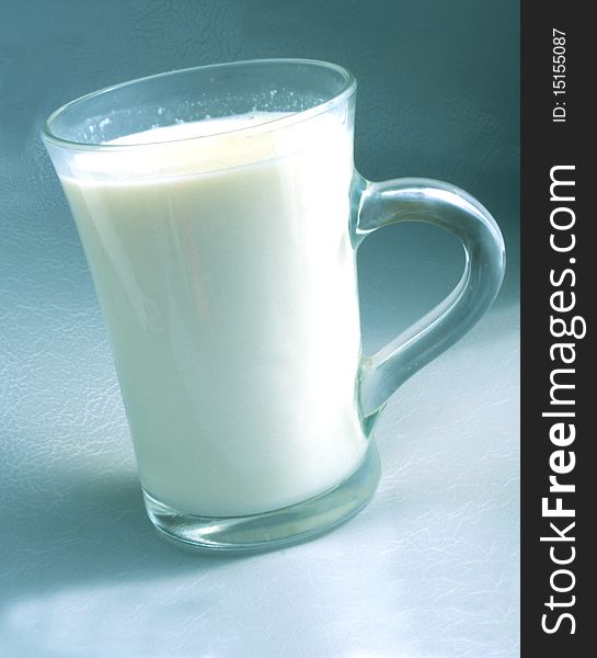 Milk in a glass beaker on a gray background
