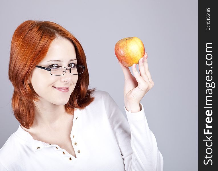 Girl with apple in hand. Studio shot.