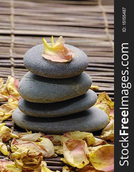 Stack of stone with rose petals. Stack of stone with rose petals