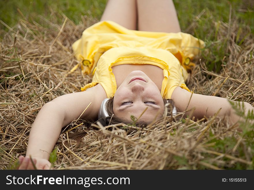 Young beautiful girl in yellow with headphones