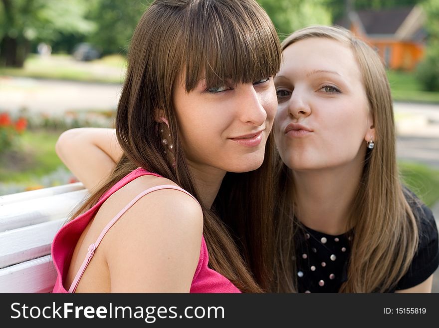 Two female friends  on bench