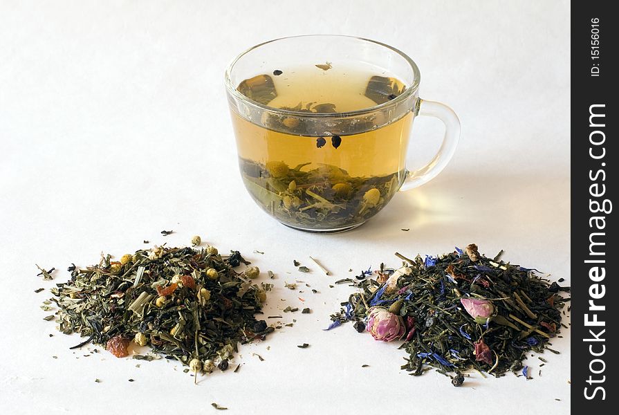 White cup with tea on a white background, alongside dry tea