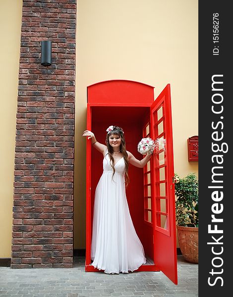 Bride in the red telephone cabin