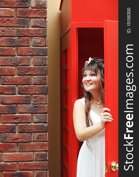 Bride in the red telephone cabin